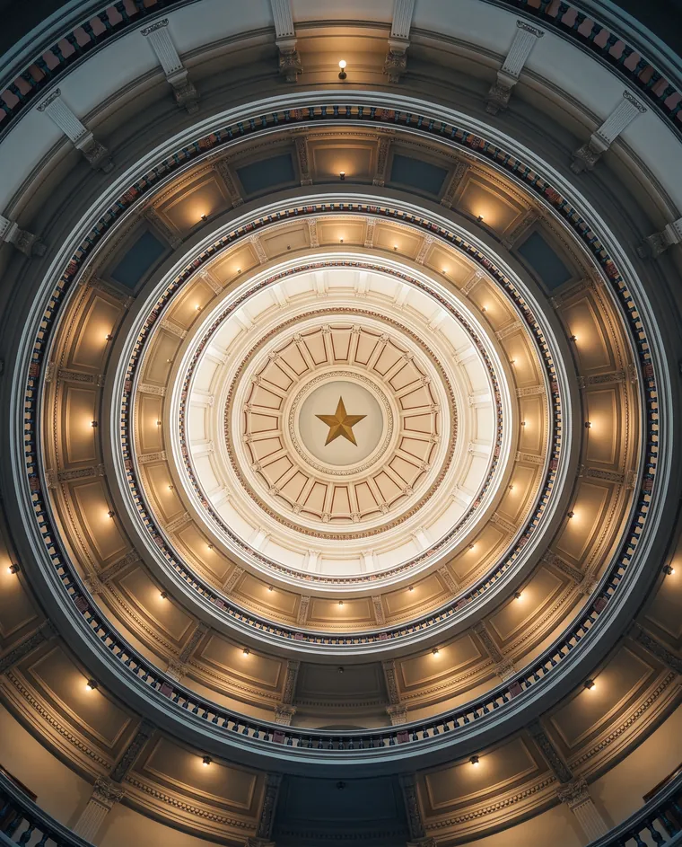 Looking up into the Texas Capitol rotunda to the gold star at the top of the dome